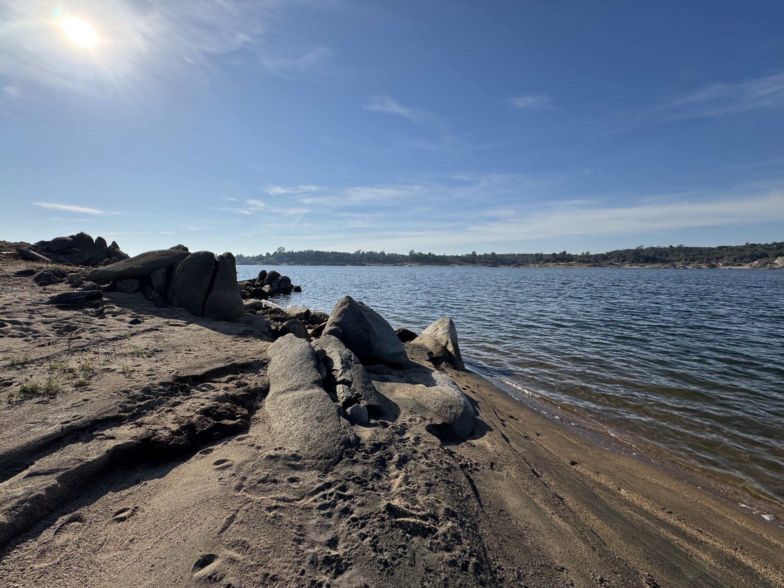 Shoreline of water, sand and rocks